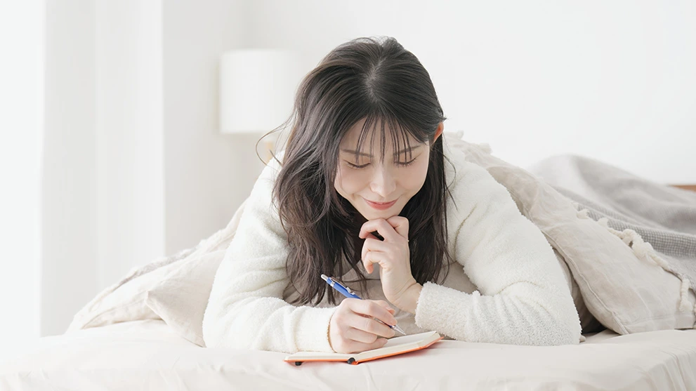 A young woman writing in her journal
